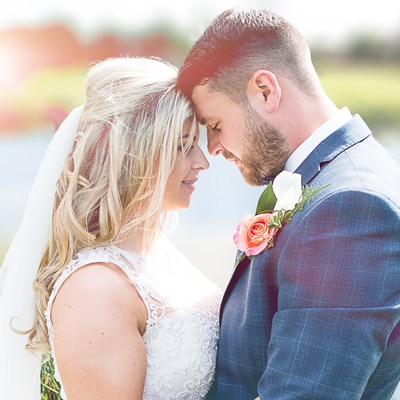 A newlywed couple in beautiful parkland.